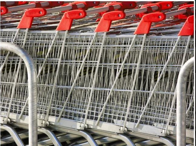 A row of shopping carts lined up in rows.