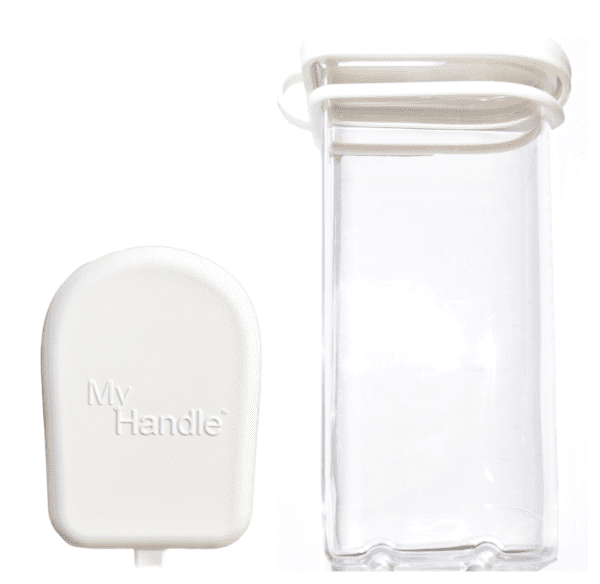 A white handle and glass container next to each other.